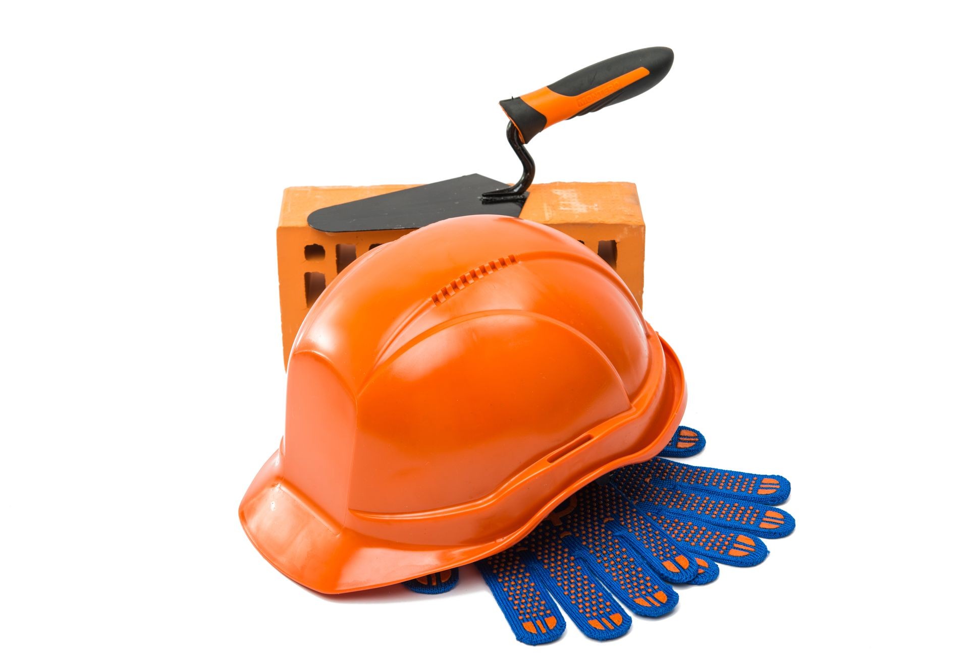 Construction helmet with steel trowel and gloves on white